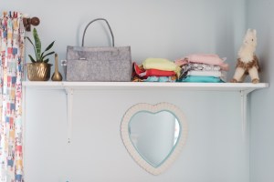 bumgenius cloth diapers on shelf in Penelope's nursery